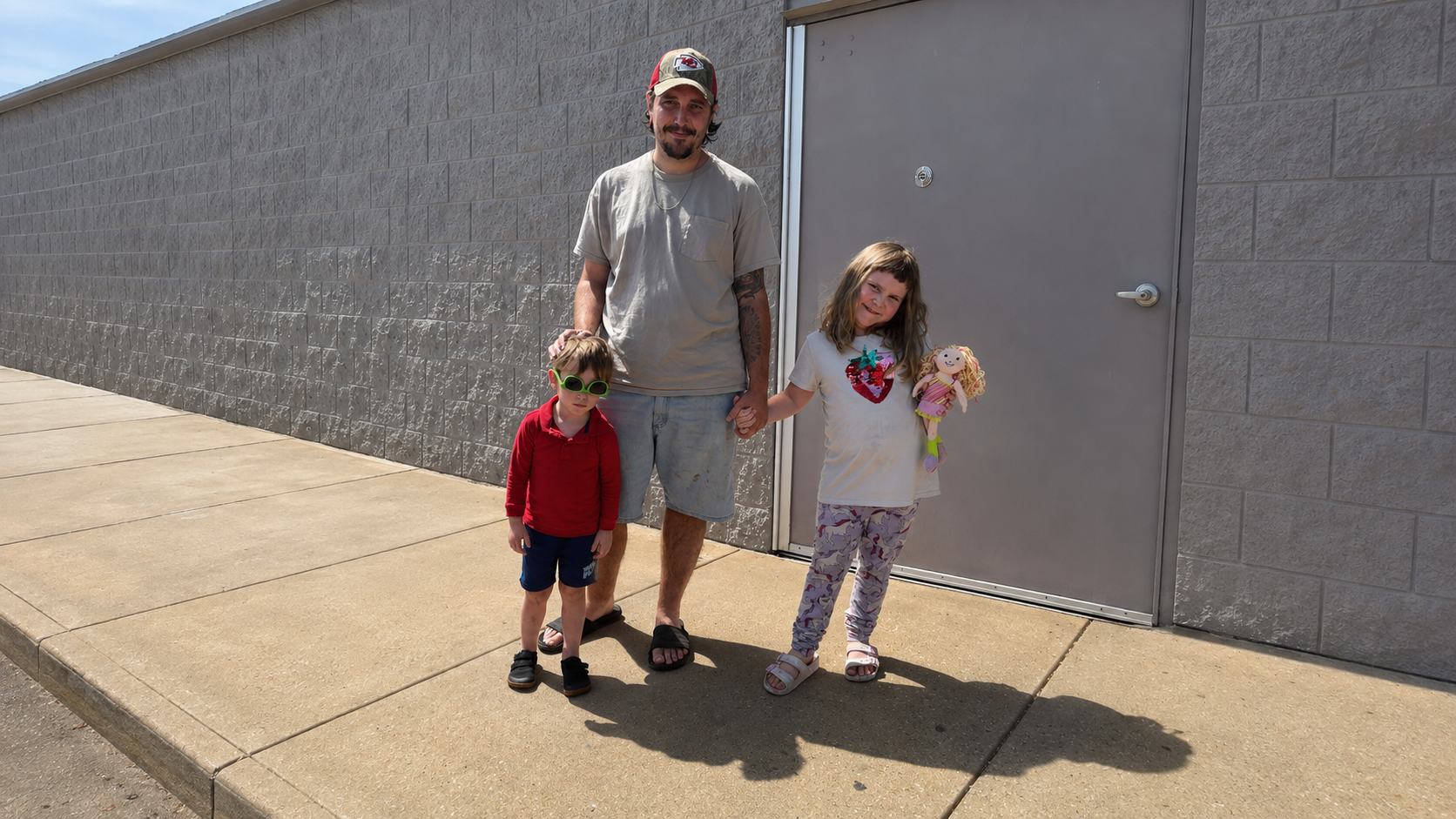 A member of the Bauman family with his children outside the Bauman Bounty workspace