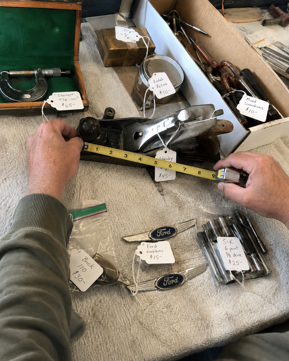 Vintage tools and parts being measured and tagged for resale